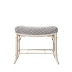 White bench with patterned cushion on a white background