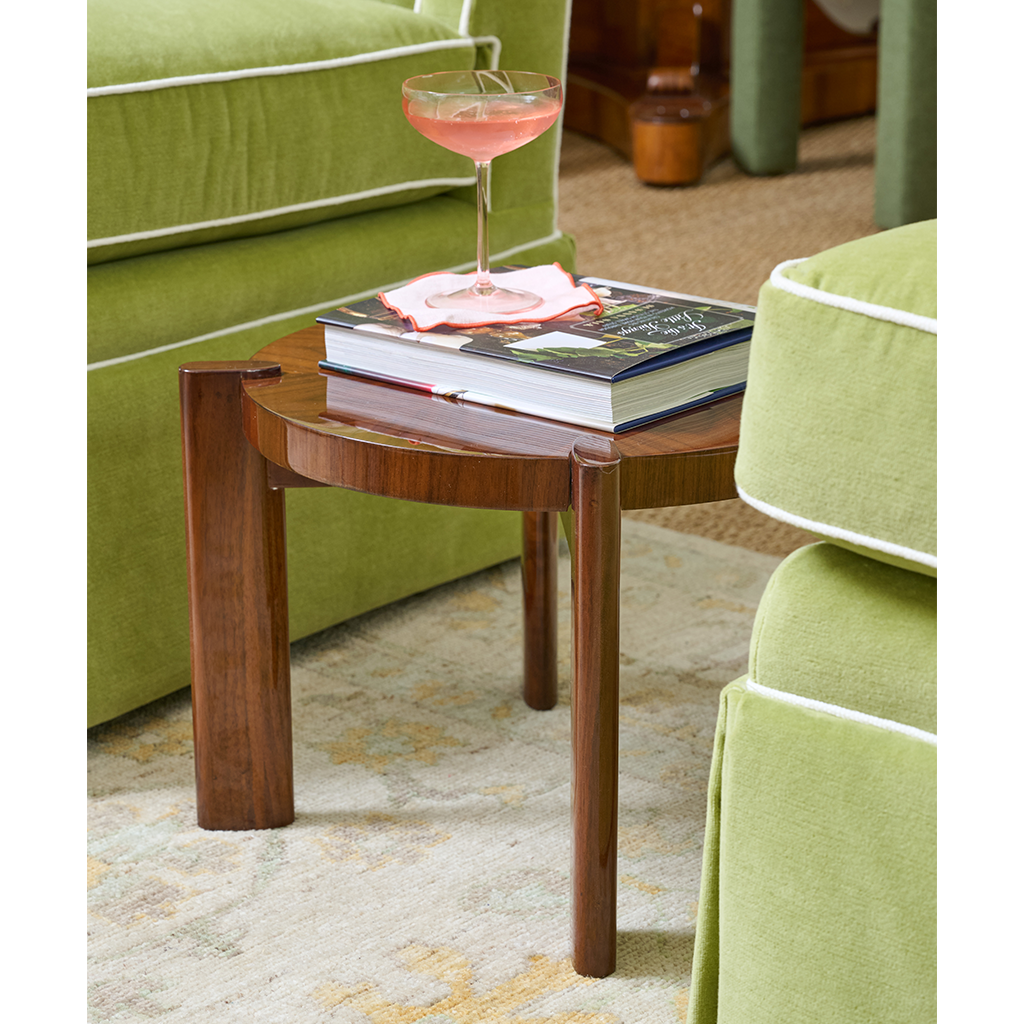 Seth drink table topped with book and cocktail glass.