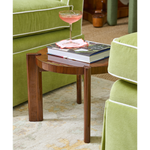 Seth drink table topped with book and cocktail glass.