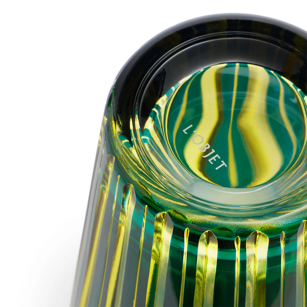 Close-up of a green and gold glass cocktail shaker with 'L'Objet' branding.