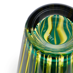 Close-up of a green and gold glass cocktail shaker with 'L'Objet' branding.