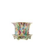 Flared porcelain jardiniere with intricate famille rose hand-painted figures and floral motifs on matching scalloped stand.