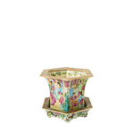 Hexagonal Famille Rose porcelain jardiniere with colorful hand-painted scenes and floral patterns, resting on a matching.