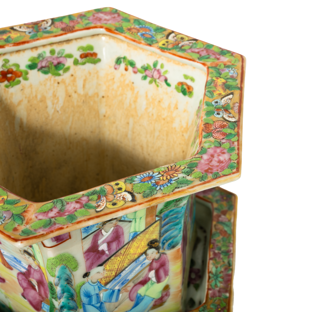 Hexagonal ceramic jardiniere with intricate Famille Rose floral and butterfly patterns in vibrant pink, green, and yellow on