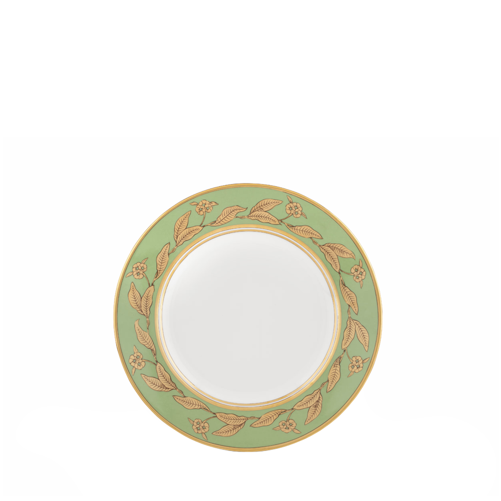 Decorative plate with gold leaf design on a white background