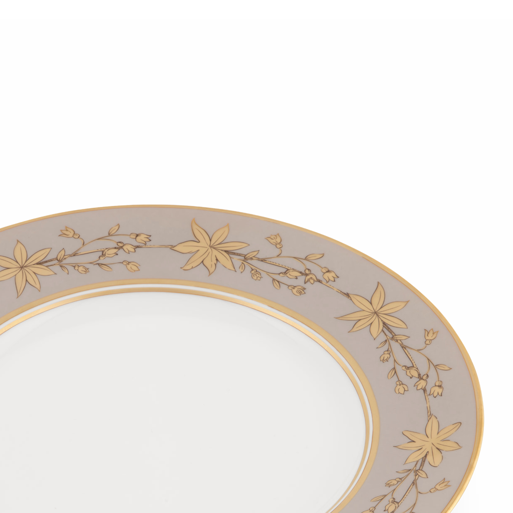 Decorative plate with gold floral patterns on a white background
