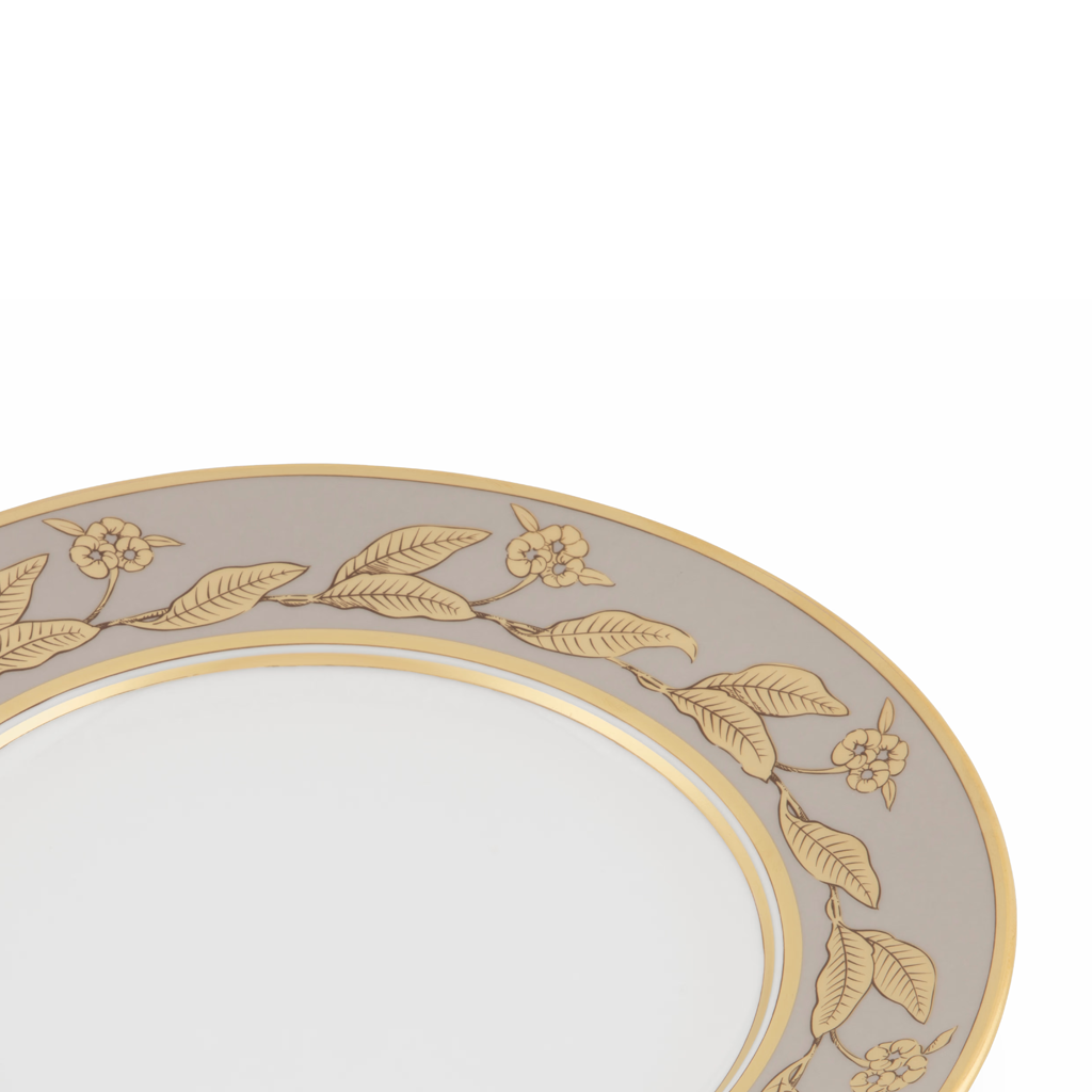 Decorative plate with gold leaf patterns on a white background