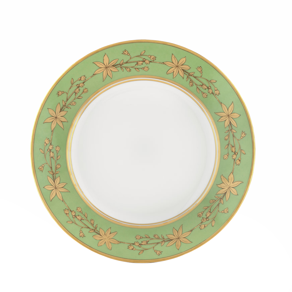 Green decorative dinner plate with gold leaf pattern on a white background