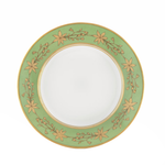 Green decorative dinner plate with gold leaf pattern on a white background