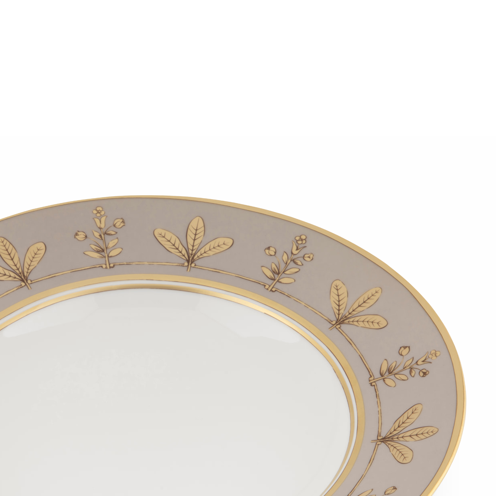 Decorative plate with gold leaf patterns on a white background