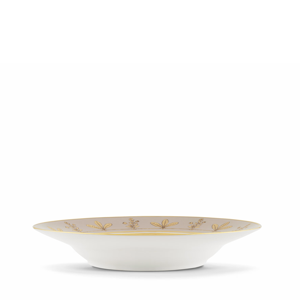 White bowl with gold decorative elements on a white background