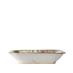 A vintage rectangular ceramic dish with a white glazed base and a hand-painted multicolor border depicting figures and landscapes.