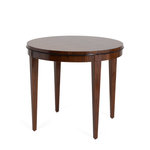 Round wooden side table with tapered legs and a smooth, polished surface in dark walnut finish.