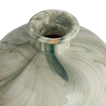 Marbled glass with green and beige swirls on a white background