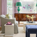 White marble Solstice Side Table with rectangular top next to gray upholstered armchair in living room setting.