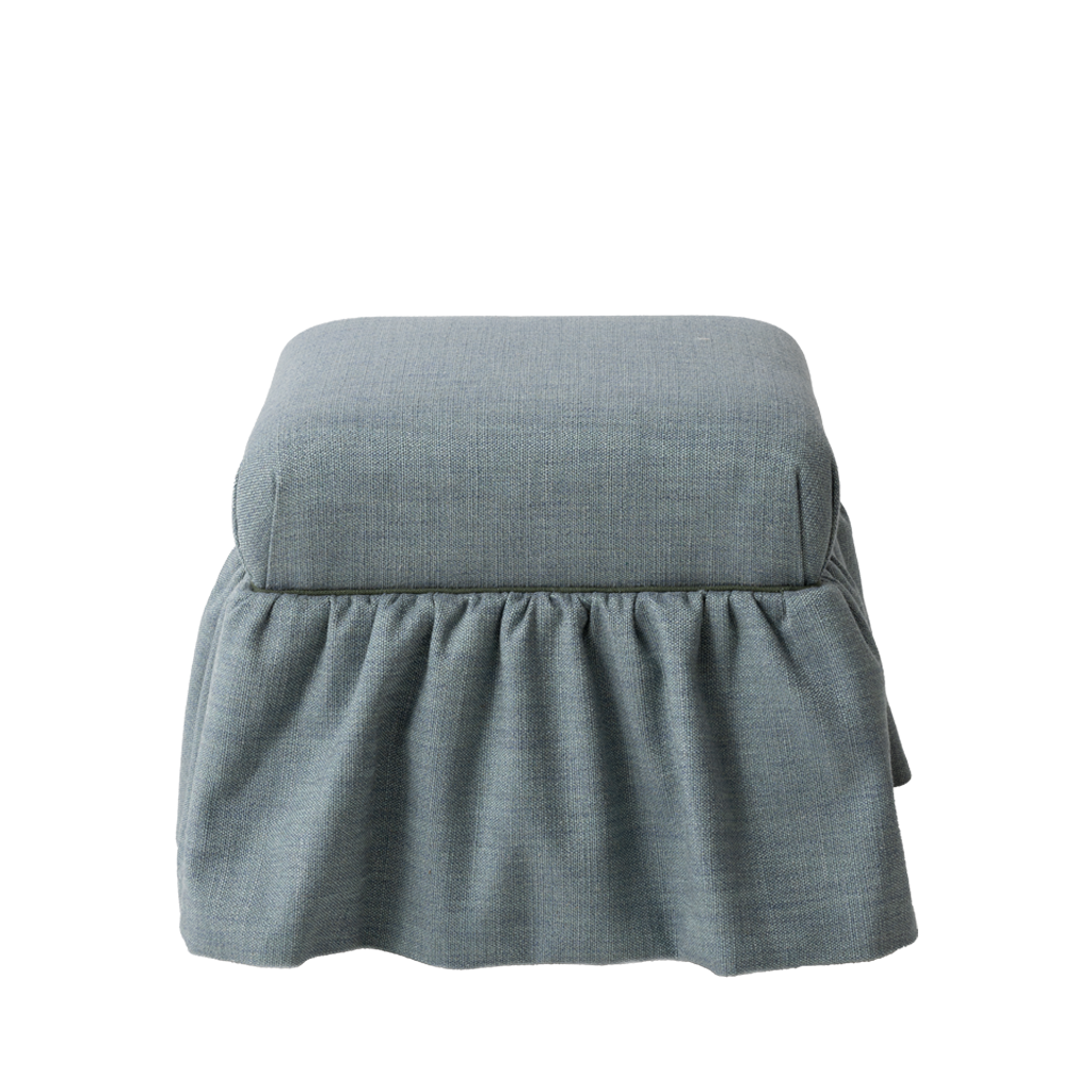 Blue upholstered ottoman with ruffle skirt