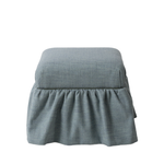 Blue upholstered ottoman with ruffle skirt