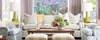 Store display including blue patterned chairs, coffee table with flowers, green sofa and light green lamps