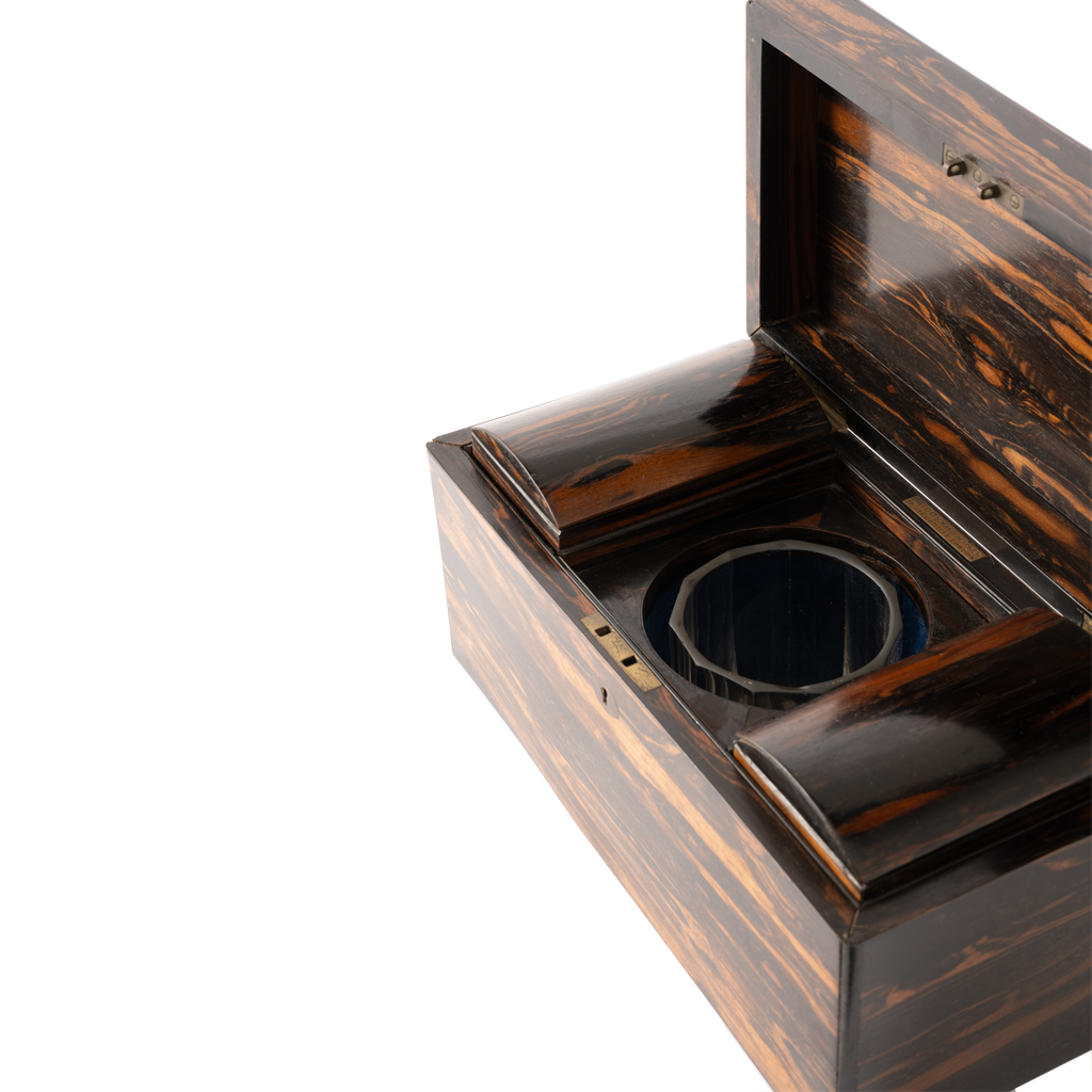A close-up of an open dark wood box with a glossy tortoiseshell wood pattern, showing the interior pot and lid, set against a plain white background.