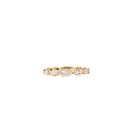 Gold ring with eternity diamonds on a white background