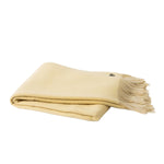A folded cream-colored wool blanket with fringed edges, displayed on a clean white background.
