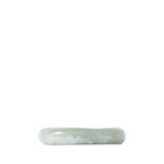 Side angle of a green resin catch-all dish on a white background