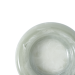 Close-up of a green resin catch-all dish on a white background