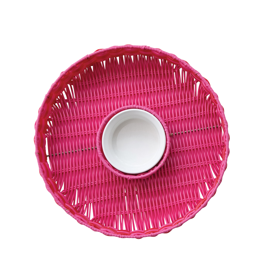 Pink woven chip and dip with a white bowl in the center on a white background