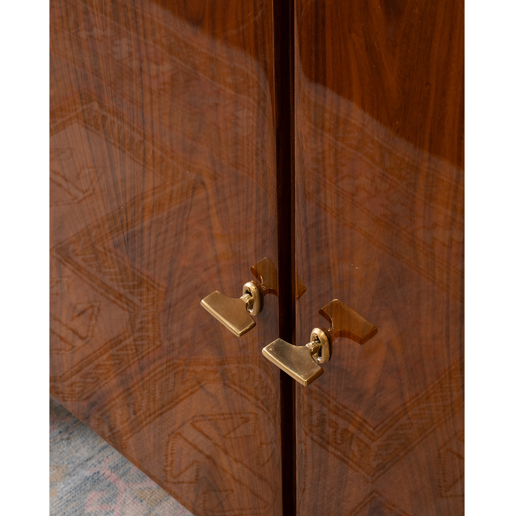 Wooden cabinet with gold handles on a white background