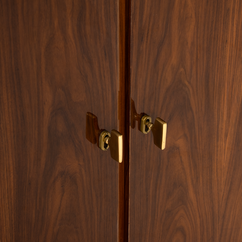 Close-up of a wooden cabinet with gold handles