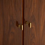 Close-up of a wooden cabinet with gold handles