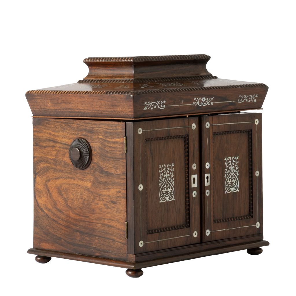 Antique jewelry box with ornate mother of pearl inlay and two doors.