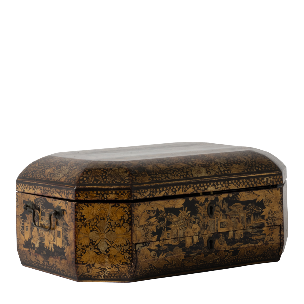 A rectangular lacquered box with a rounded lid, decorated with intricate gold and black landscape and floral patterns, shown against a plain white background.