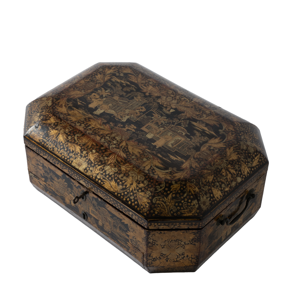 An antique octagonal wooden box with a dark brown and black lacquered finish, decorated with intricate gold and brown floral and landscape motifs on the lid, shown on a plain white background.
