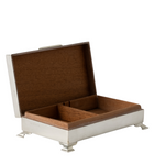 An open rectangular wood-lined box with a silver metal exterior stands on four decorative feet and features two interior compartments for storage. The hinged lid reveals the warm wood interior, giving the box an elegant, vintage appearance.
