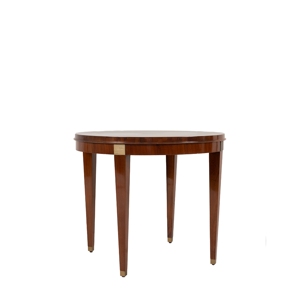 Round side table with brass detailing and a mahogany wood top, known as the Audrey Side Table.