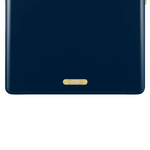A close-up of the lower front of a navy blue FIELDBAR cooler highlights its smooth, rounded design and a small gold nameplate centered near the base. The gold plaque is engraved with the model name "Gin Trunk" and "Est. MMXXI," adding a refined finishing detail.