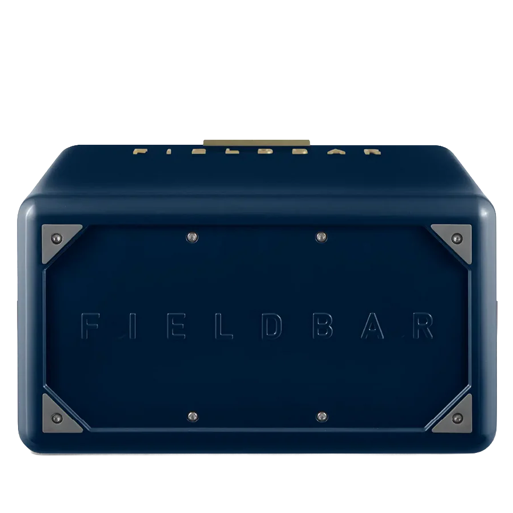 The underside of the navy blue FIELDBAR cooler is shown, featuring an embossed FIELDBAR logo centered on the base. Reinforced metal corner plates and exposed screws add durability while maintaining the cooler's premium design.