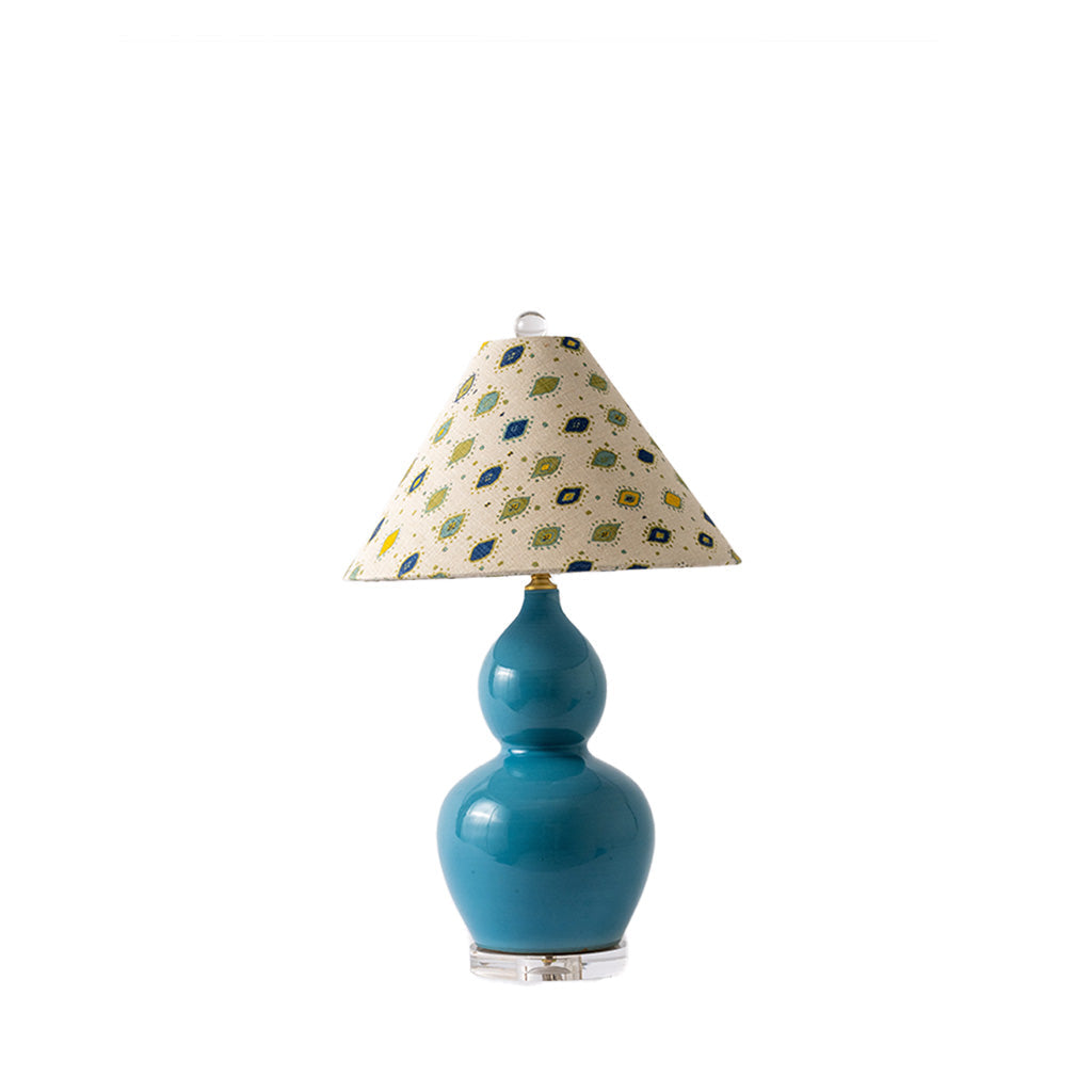 A table lamp with a glossy teal-blue gourd-shaped ceramic base and a conical fabric shade featuring a small multicolor floral pattern on a cream background, set against a plain white background.