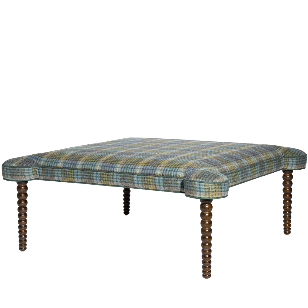 Plaid ottoman with wooden legs on a white background