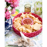 pink chip and dip server with salsa on a blue patterned tabelcloth