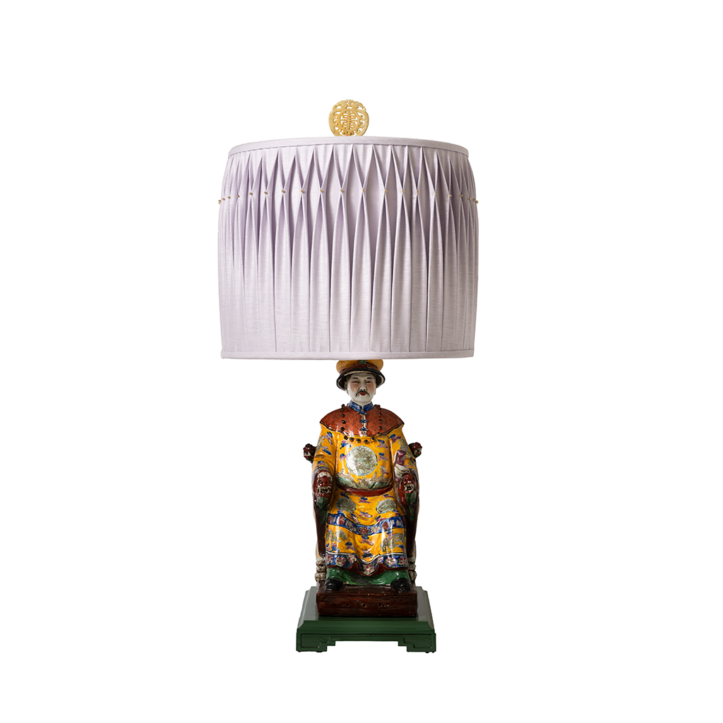 Decorative lamp with a figurine base on a white background