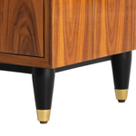 Mid-century modern wooden side table corner with black tapered legs and brass caps.