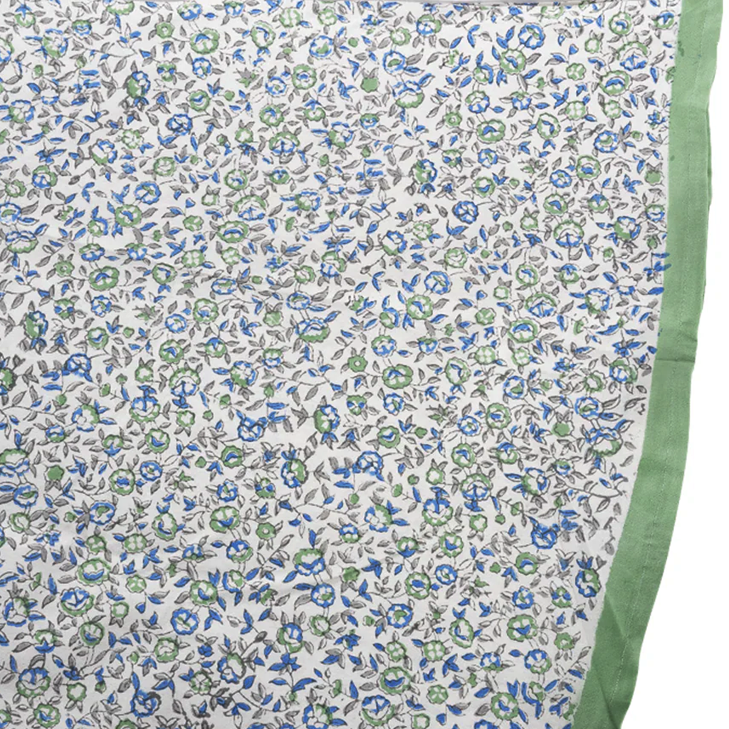 Floral patterned fabric with green border on a white background