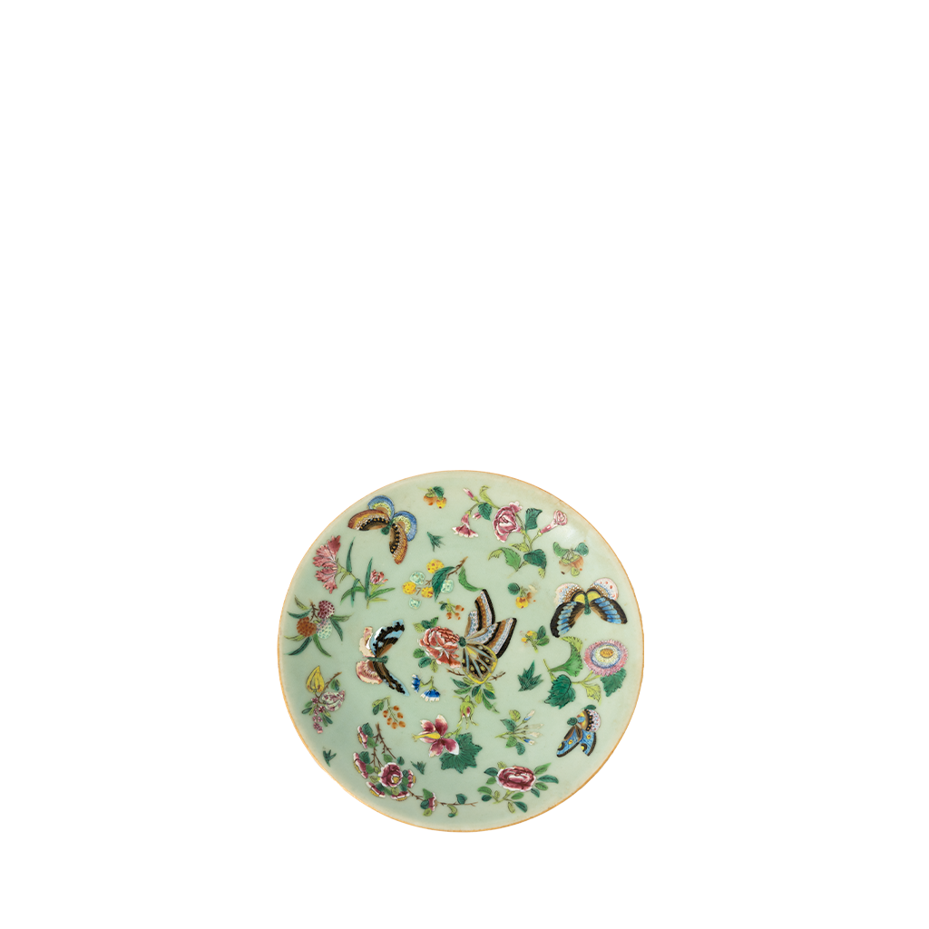 Decorative plate with floral and butterfly design on a light green background