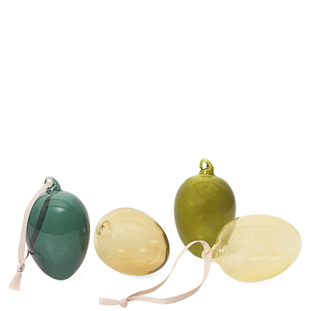 A set of four dark glass Easter eggs in green, blue, beige, and brown colors, with two eggs partially opened to display the painted patterns inside.
