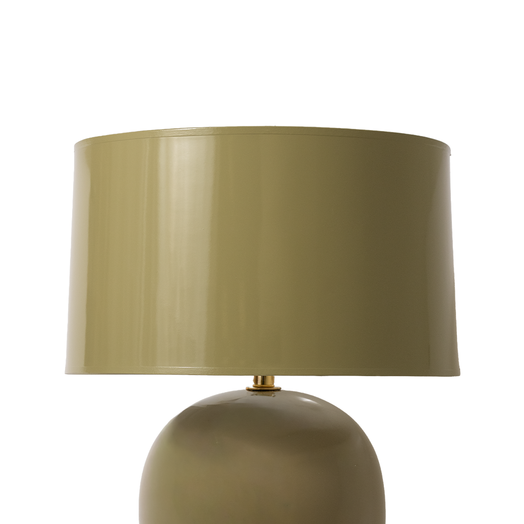 Green table lamp with a matching shade on a white background