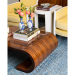 brown coffee table with books and vases on top