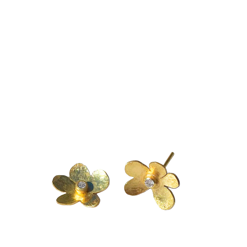 Gold flower-shaped earrings with a central gemstone on a white background