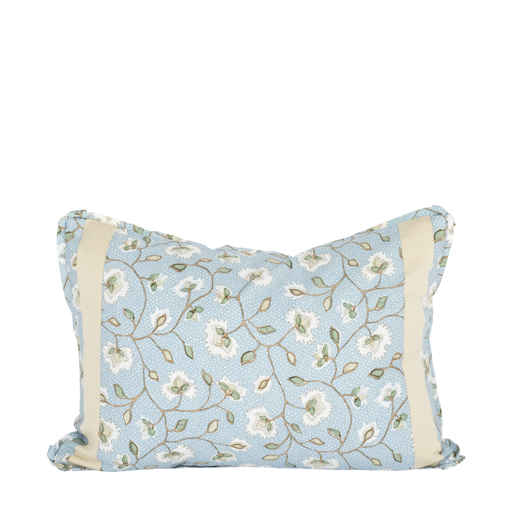 blue and white pillow with tree branches